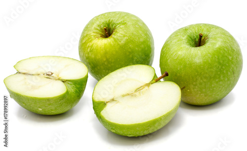 Sliced apple Granny Smith, two whole and two halves, isolated on white background 