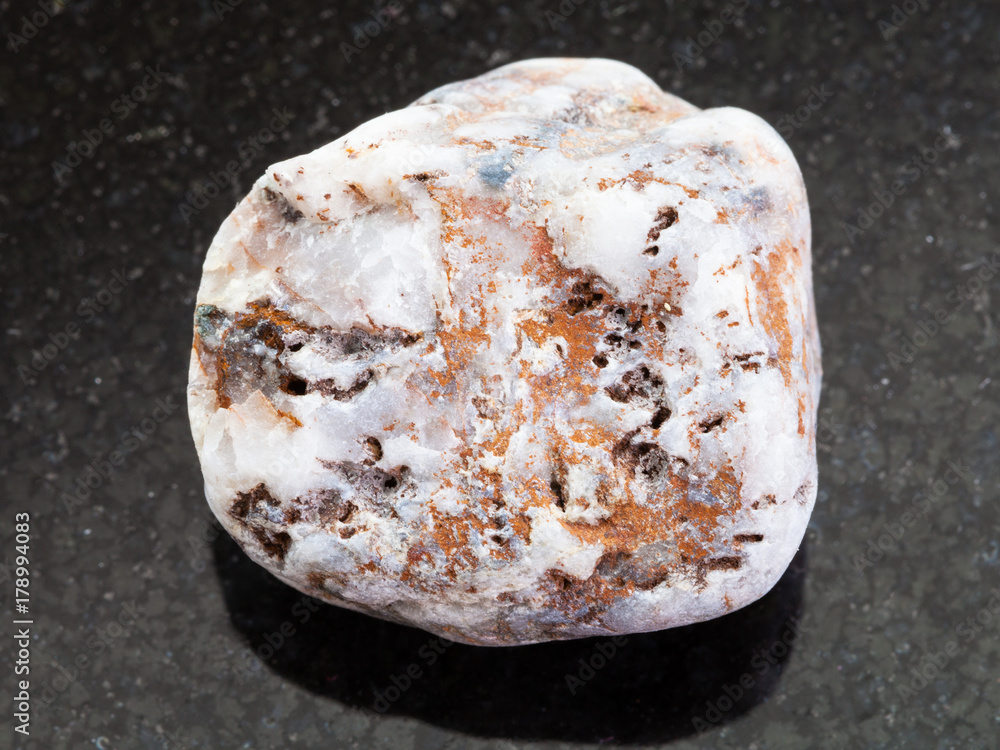 rough marble pebble on dark background rough marble pebble on dark background