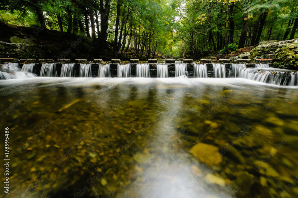 Water flowing between stepping stones on the Shimna River, Tollymore Forest, Northern Ireland, featured in Game of Thrones