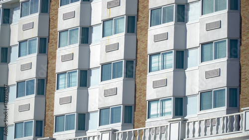 Obraz na płótnie Establishing shot day time exterior close up hotel room window facade. Generic architecture design of bay windows and air conditioning units of five star vacation resort location w salonie