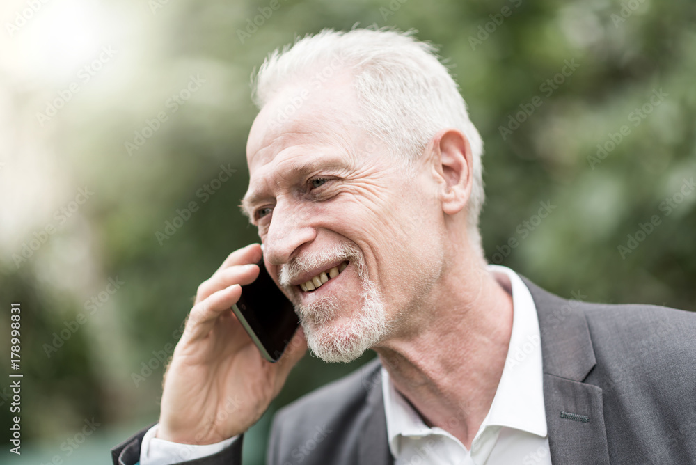 Mature man talking on mobile phone Mature man talking on mobile phone