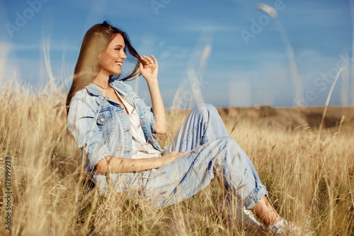 Young woman enjoying a sunny day in the meadow