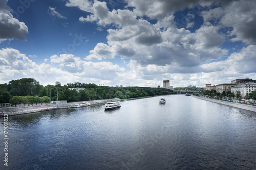 view of the Moskow river with several tourist boats on a sunny day.