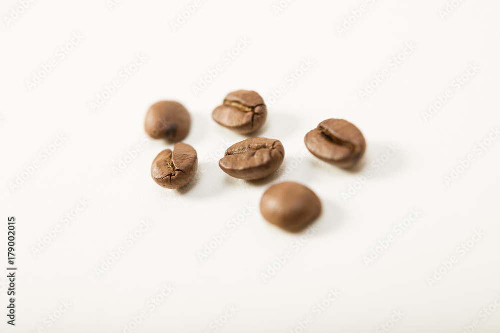 macro image of dark aromatic coffee beans on white background with copy space.shallow depth of field. macro image of dark aromatic coffee beans on white background with copy space.shallow depth of field.