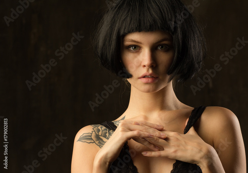 Young brunette with a piercing meaningful gaze. Natural skin without retouch.