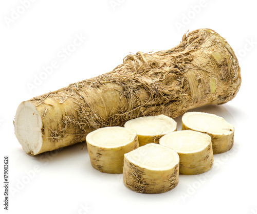One half of fresh horseradish root and sliced circles isolated on white background photo