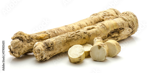 Fresh horseradish root isolated on white background two whole and sliced circles