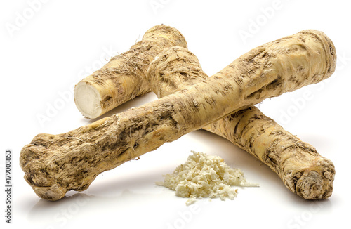 Two whole, one half and freshly grated mash of horseradish root, isolated on white background