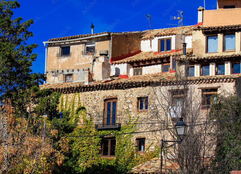 Bright colorful picture of old spanish buildings in Cuenca, blue sky, sunny day