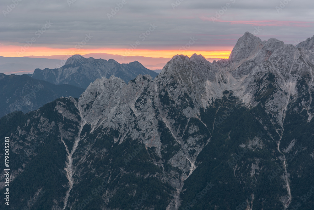 Spectacular sunrise line behind a mountain ridge.