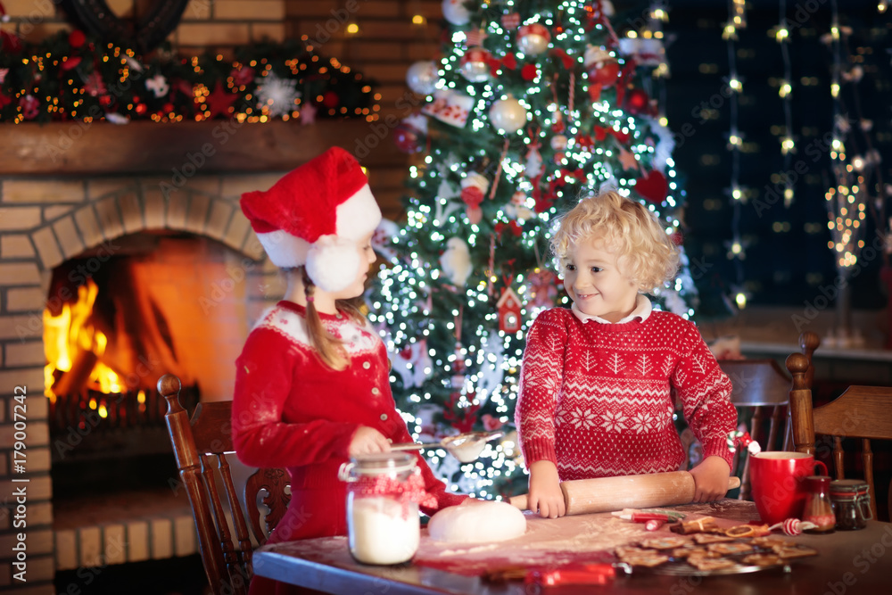 Child baking Christmas cookies. Kids bake for Xmas Child baking Christmas cookies. Kids bake for Xmas