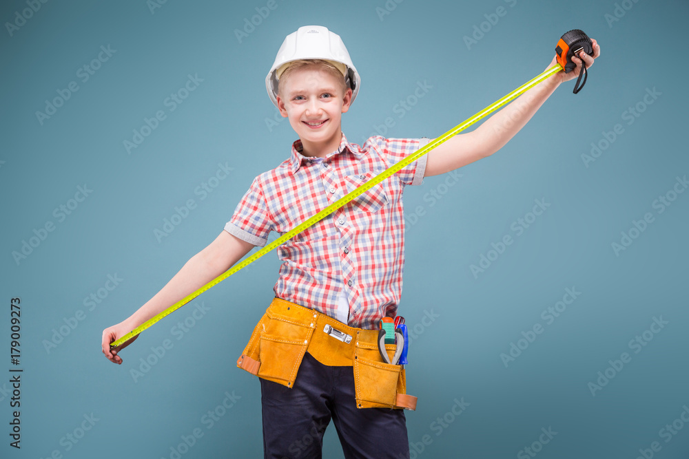 portrait of a young builder in a helmet and a tape measure in his hand portrait of a young builder in a helmet and a tape measure in his hand