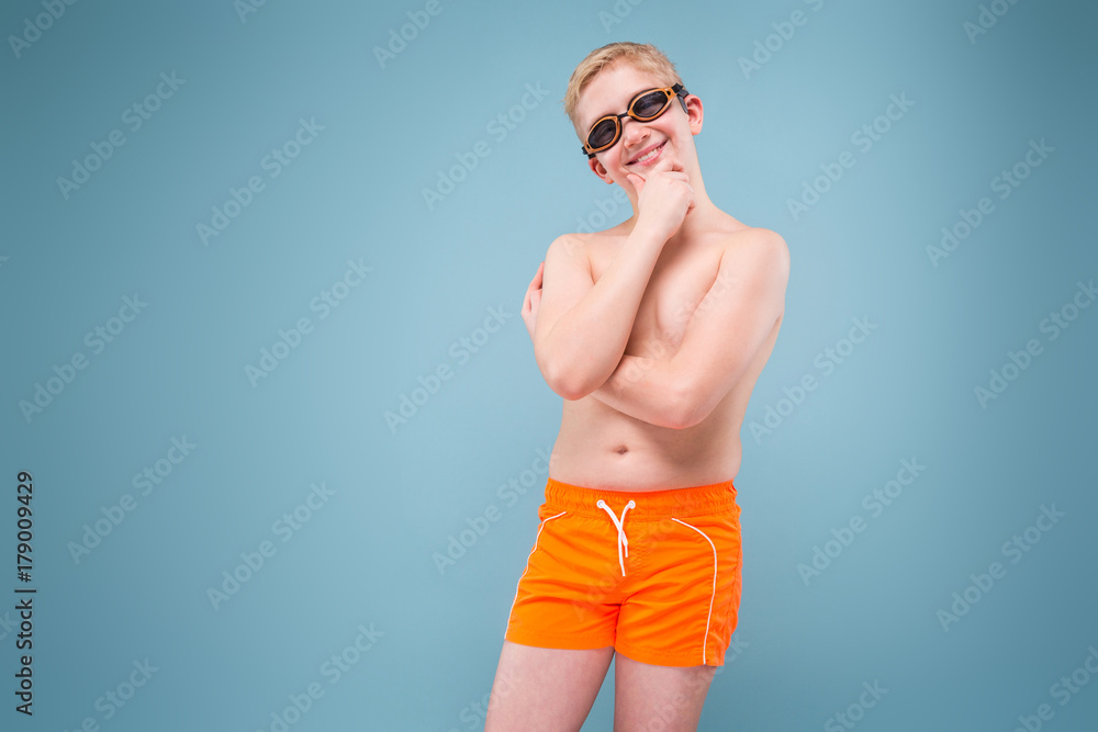 blond student in swimming trunks and goggles for swimming