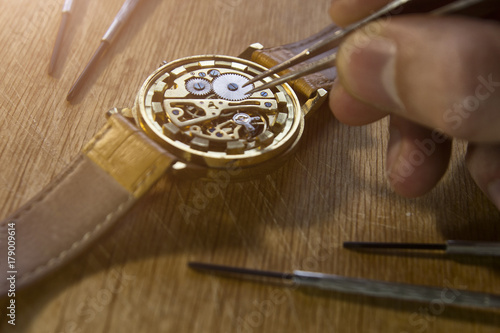Watchmaker is repairing the mechanical watches in his workshop