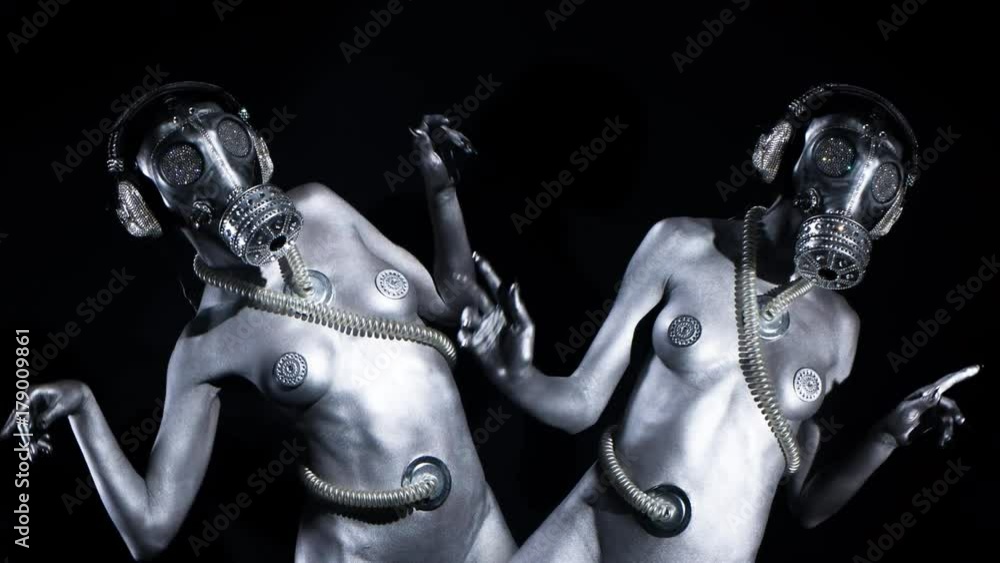 sexy woman dances in silver body paint with a gas mask covered in sparkling crystals. this is a special handmade item from our studio. how to survive the apocalypse in bling bling style