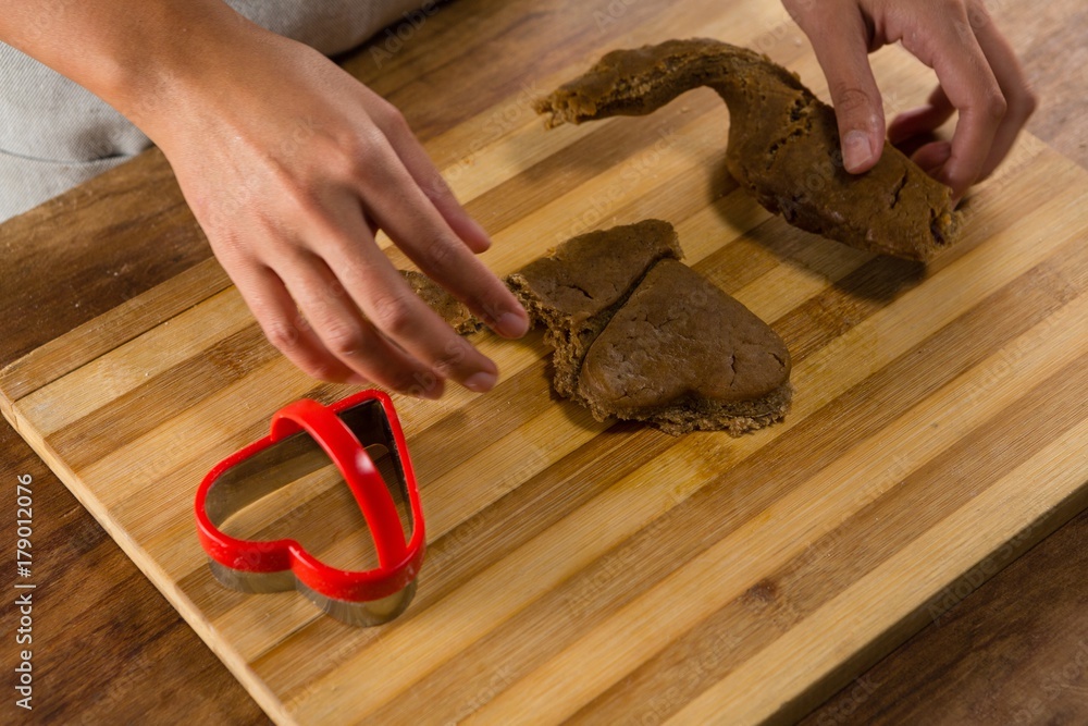 Fotografie Man molding gingerbread dough on wooden board