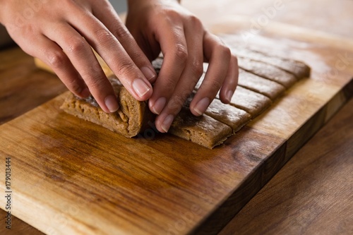 Woman arranging dough on chopping board
