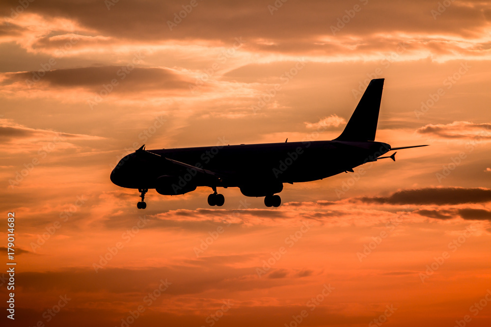 Airplane landing at sunset Airplane landing at sunset