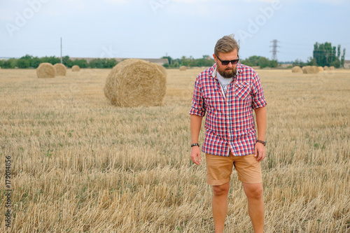 man resting after hay in haystacks photo