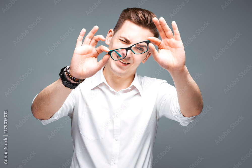 Handsome mature businessman in costly watch, black glasses and white shirt Handsome mature businessman in costly watch, black glasses and white shirt