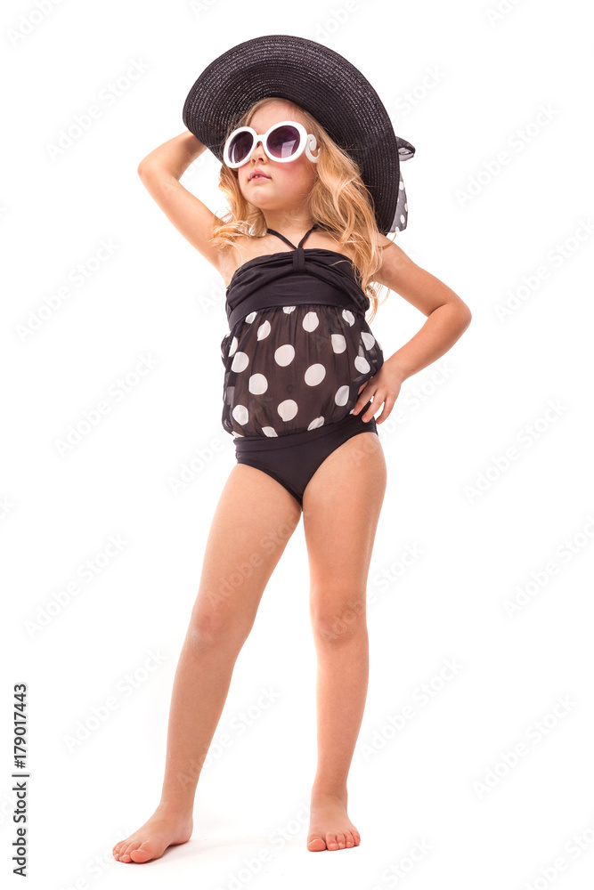 Attractive little girl in in black swimwear, white sunglasses and black hat Attractive little girl in in black swimwear, white sunglasses and black hat
