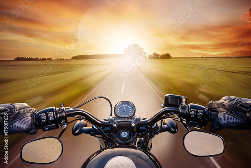 Fototapeta POV shot of young man riding on a motorcycle