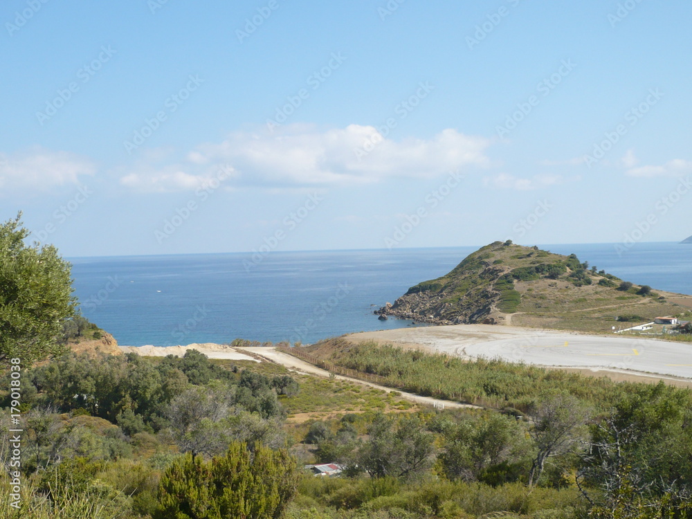 Airport landing strip very close to the street and beach Airport landing strip very close to the street and beach