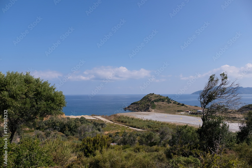 Airport landing strip very close to the street and beach Airport landing strip very close to the street and beach