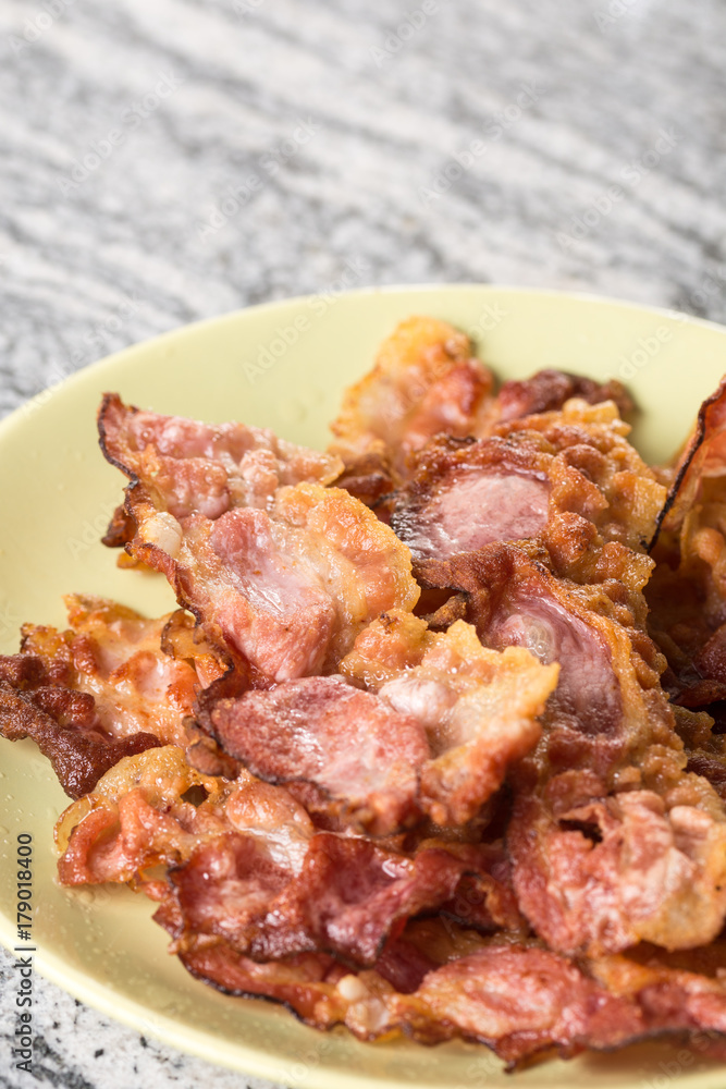 Closeup macro of crisp fried bacon on the plate Closeup macro of crisp fried bacon on the plate