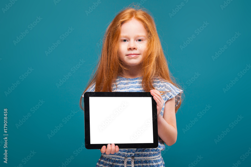 Beauty little girl in tee shirt with long hair hold tablet Beauty little girl in tee shirt with long hair hold tablet