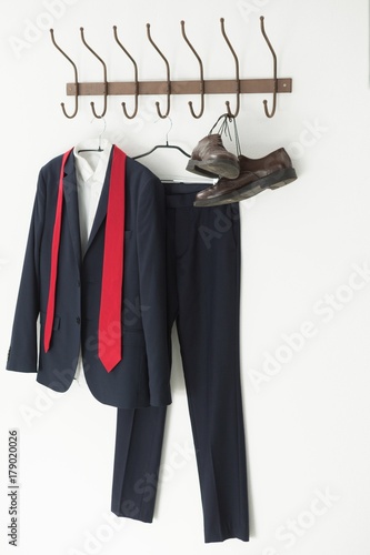 Full suit and shoes hanging on hook