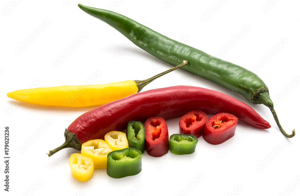 Whole Chilli peppers and slices isolated on white background three colors composition (red, yellow, green)