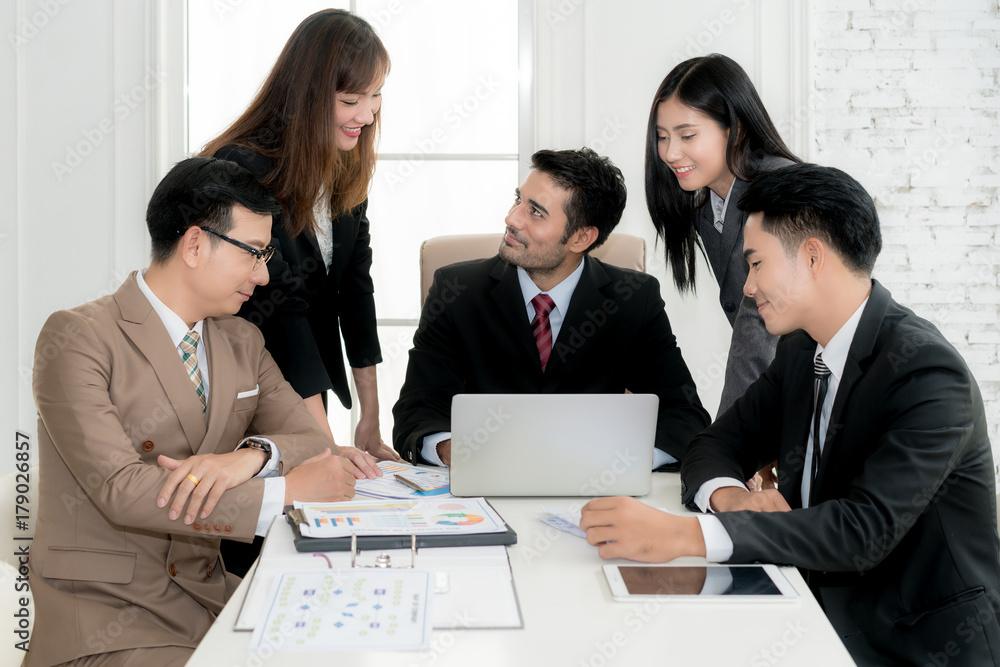 Group of multi-ethnic business partners discussing ideas in meeting room at office. Business people meeting corporate communication teamwork concept. Group of multi-ethnic business partners discussing ideas in meeting room at office. Business people meeting corporate communication teamwork concept.
