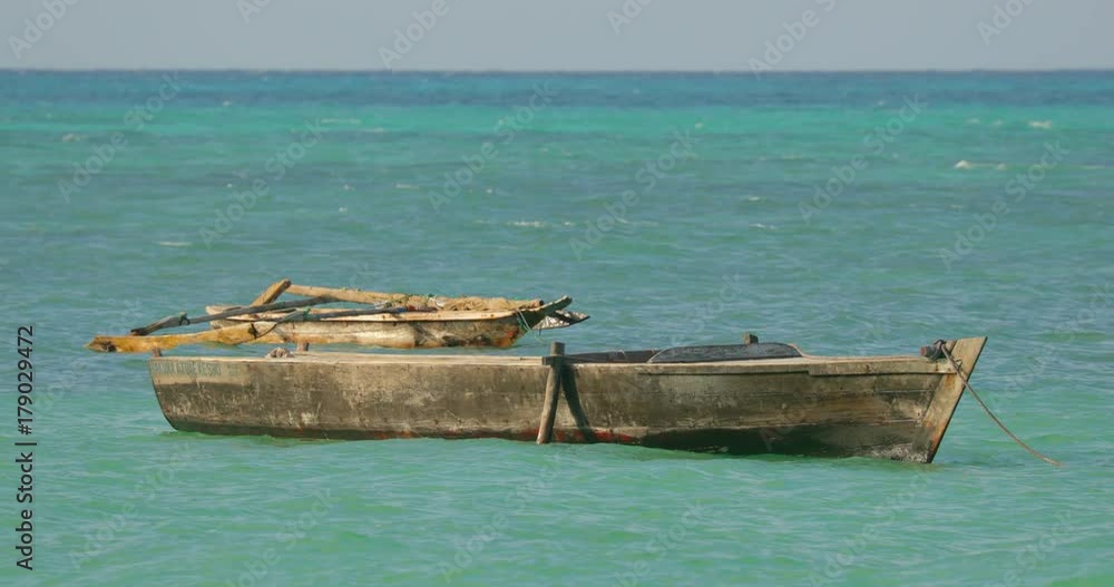 Slowmotion of a wooden fishing boat in the ocean at Zanzibar islands. Africa Slowmotion of a wooden fishing boat in the ocean at Zanzibar islands. Africa