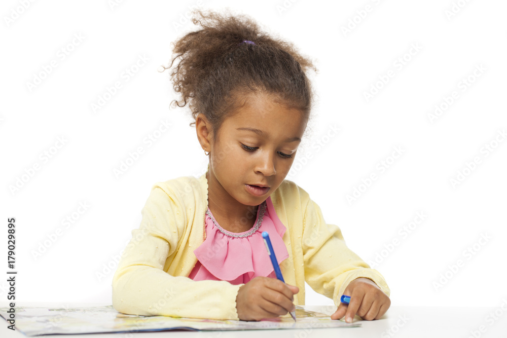 Young African girl writing in notebook Young African girl writing in notebook