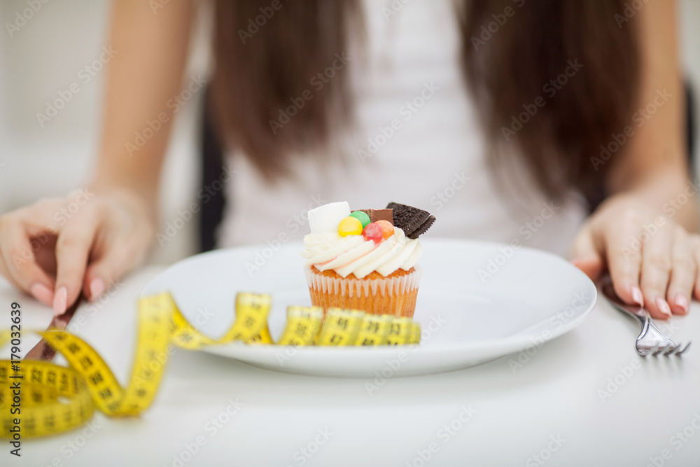 Young woman with plate of sweets. Concept of diet. Healthy food. Young woman with plate of sweets. Concept of diet. Healthy food.