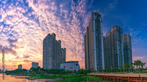 Ho Chi Minh City, Vietnam - November 30th, 2017: Sunset in urban areas along river with skyscrapers read shine by sky dramatic create beauty of urban development in Ho Chi Minh City, Vietnam