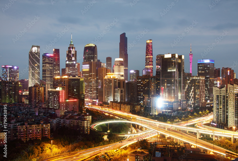 Highways and skyscrapers illuminated at dusk, Guangzhou, China Highways and skyscrapers illuminated at dusk, Guangzhou, China