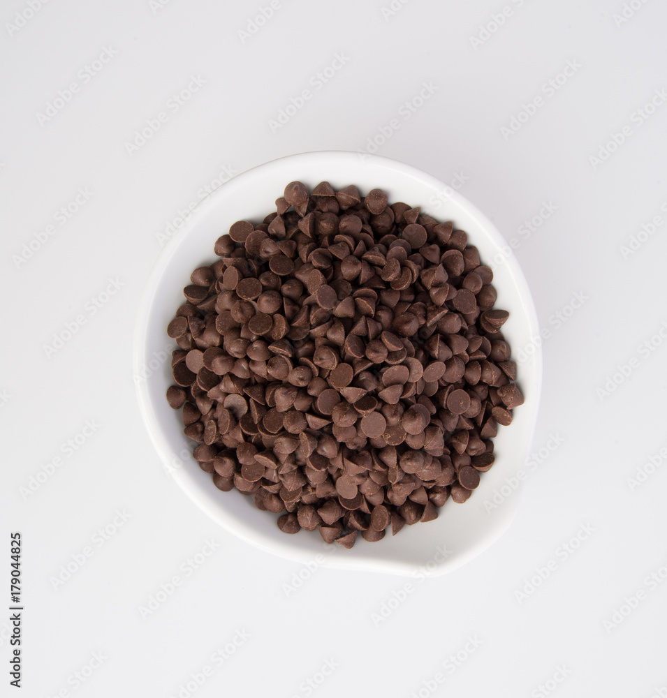 Chocolate chip morsels spread on a background. Chocolate chip morsels spread on a background.