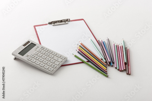 calculator with clipboard, color pencil on the white background.