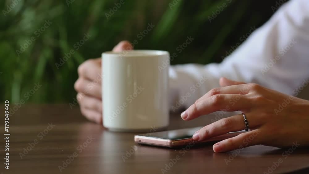 close up of a young independent,, beautiful woman mixing her morning coffee at cafe. close up of a young independent,, beautiful woman mixing her morning coffee at cafe.