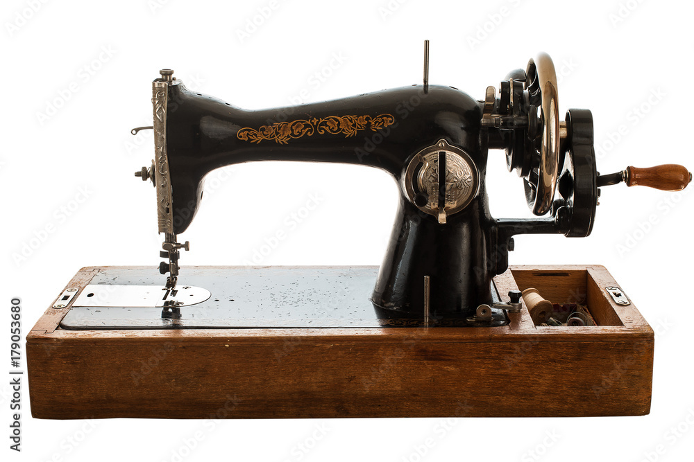 Old sewing machine on white background.