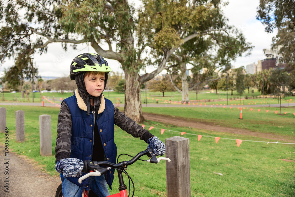 Naklejka premium Boy riding bicycle in Adelaide CBD