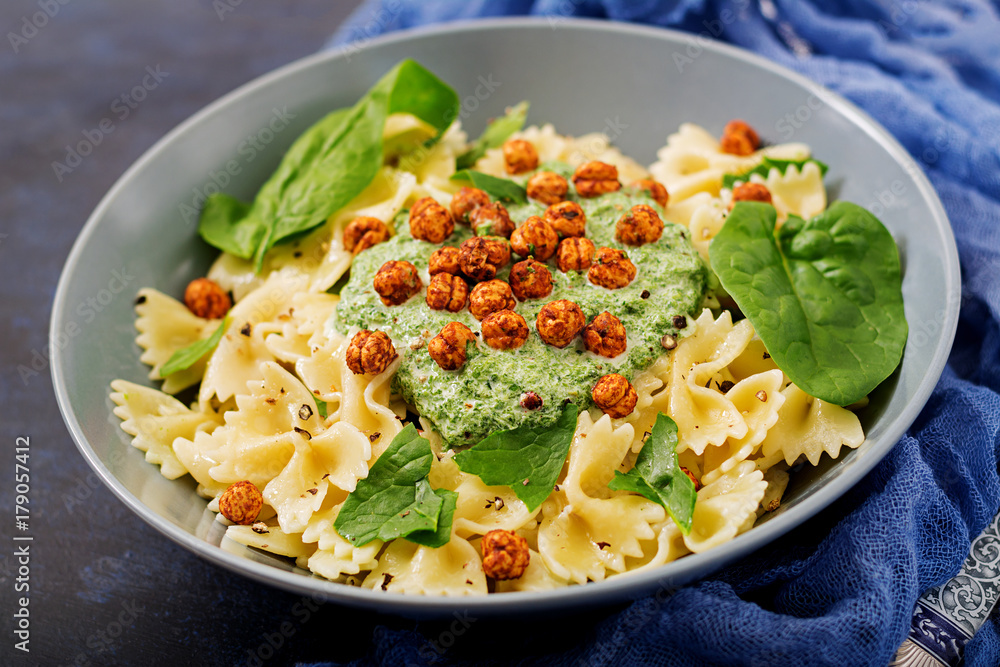 Vegan Farfalle pasta with spinach sauce with fried chickpeas. Proper nutrition. Sports nutrition. Dietary menu. Vegan Farfalle pasta with spinach sauce with fried chickpeas. Proper nutrition. Sports nutrition. Dietary menu.
