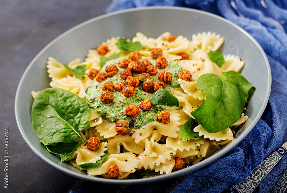 Vegan Farfalle pasta with spinach  sauce with fried chickpeas. Proper nutrition. Sports nutrition. Dietary menu.