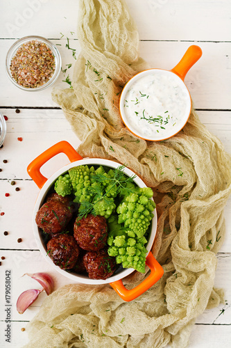 Baked beef meatballs and garnish from boiled cabbage romanesko. Dietary menu. Proper nutrition. Flat lay. Top view photo