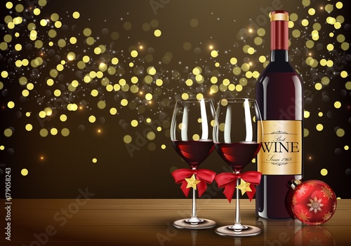 Red wine glass with wine bottle and christmas ball on light bokeh background