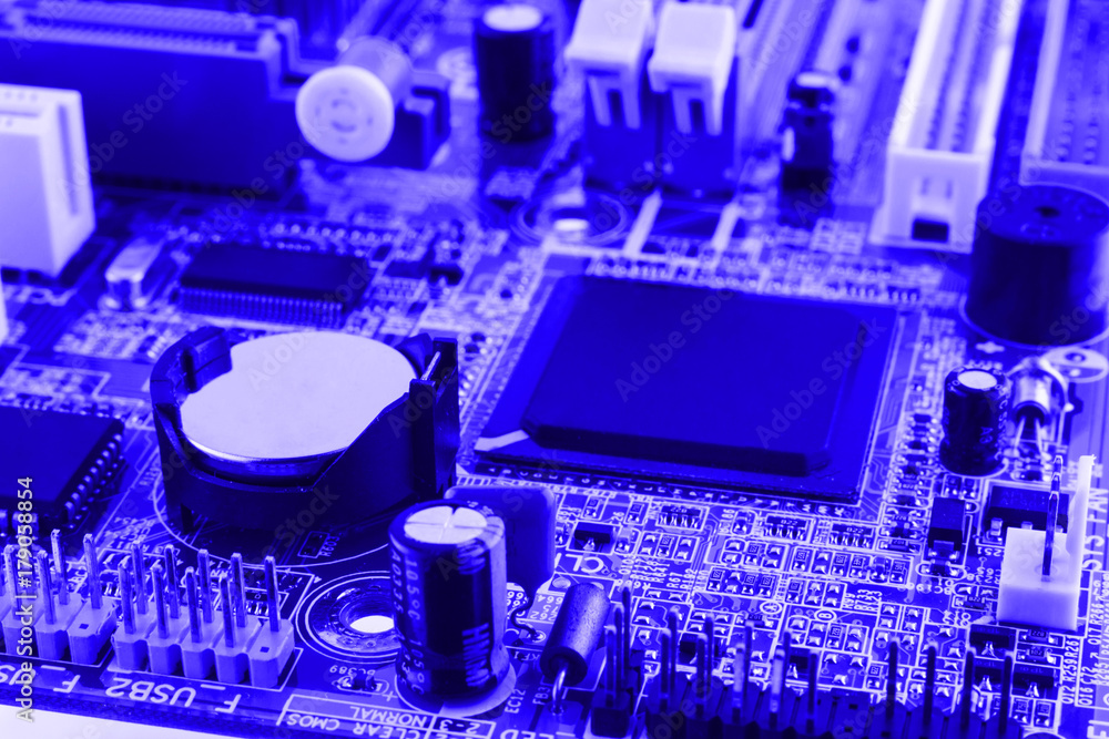Integrated semiconductor microchip on blue circuit board representative of the high tech industry and computer science Integrated semiconductor microchip on blue circuit board representative of the high tech industry and computer science