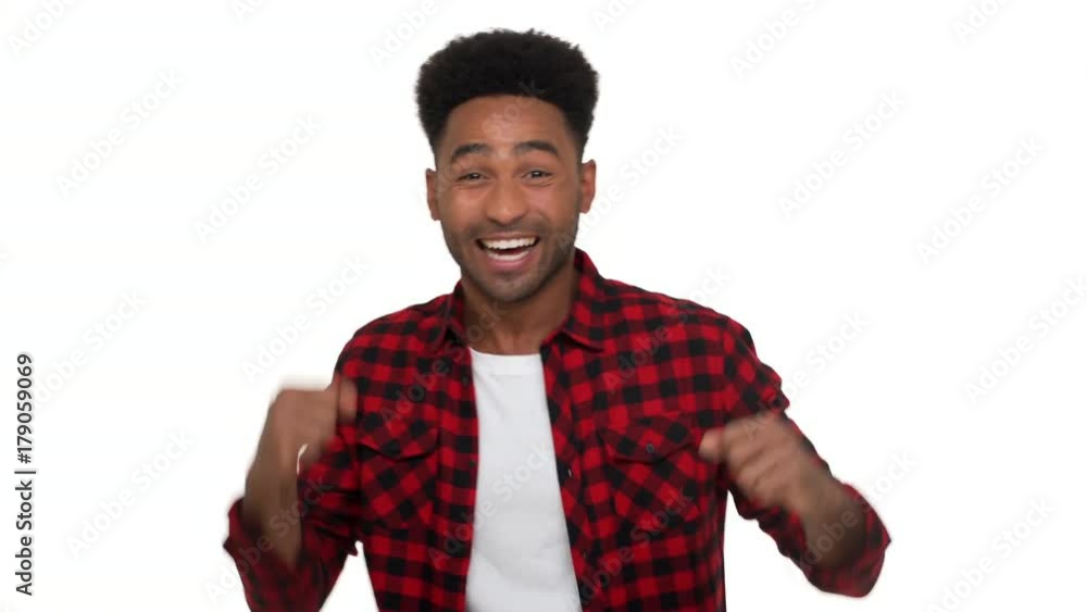 portrait of excited mixed-race man with super hairdo and bristle being excited expressing delight behaving like winner clenching fists isolated over white background. Concept of emotions portrait of excited mixed-race man with super hairdo and bristle being excited expressing delight behaving like winner clenching fists isolated over white background. Concept of emotions