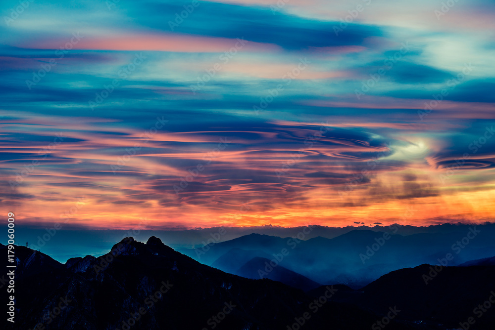 lenticular clouds at sunset over italian Alps - Lombardy Italy

